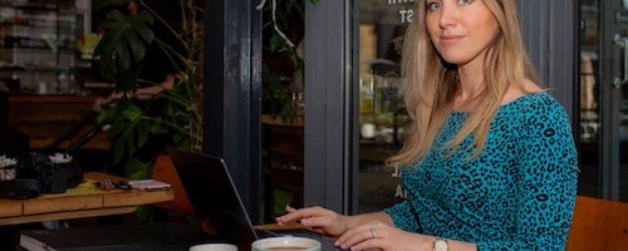 Female Executive Having Coffee In An Urban coffee shop with laptop working. Personal Branding Photography by Emma Milestone